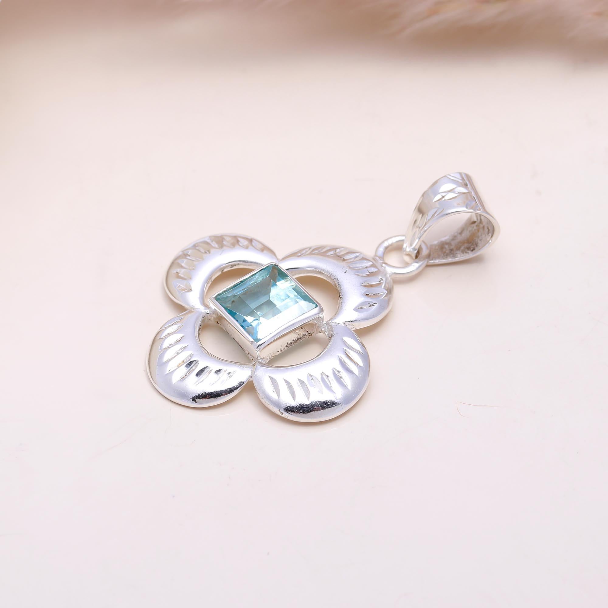 The Azure Clover: Blue Topaz Cutout Flower Pendant