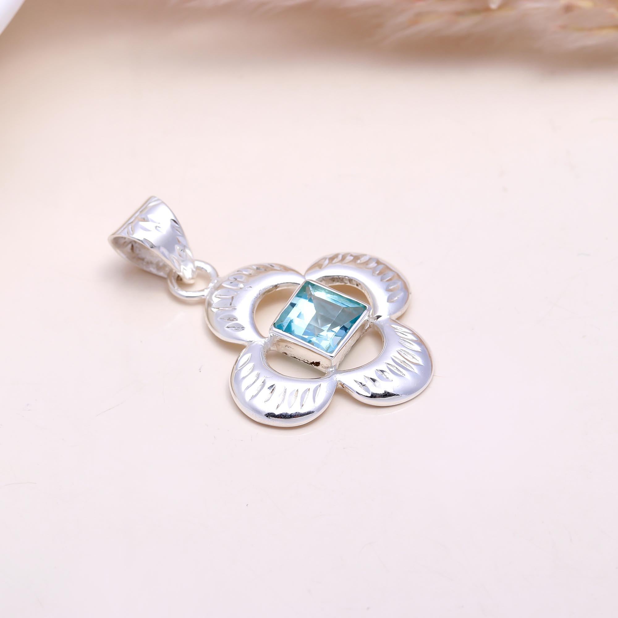 The Azure Clover: Blue Topaz Cutout Flower Pendant