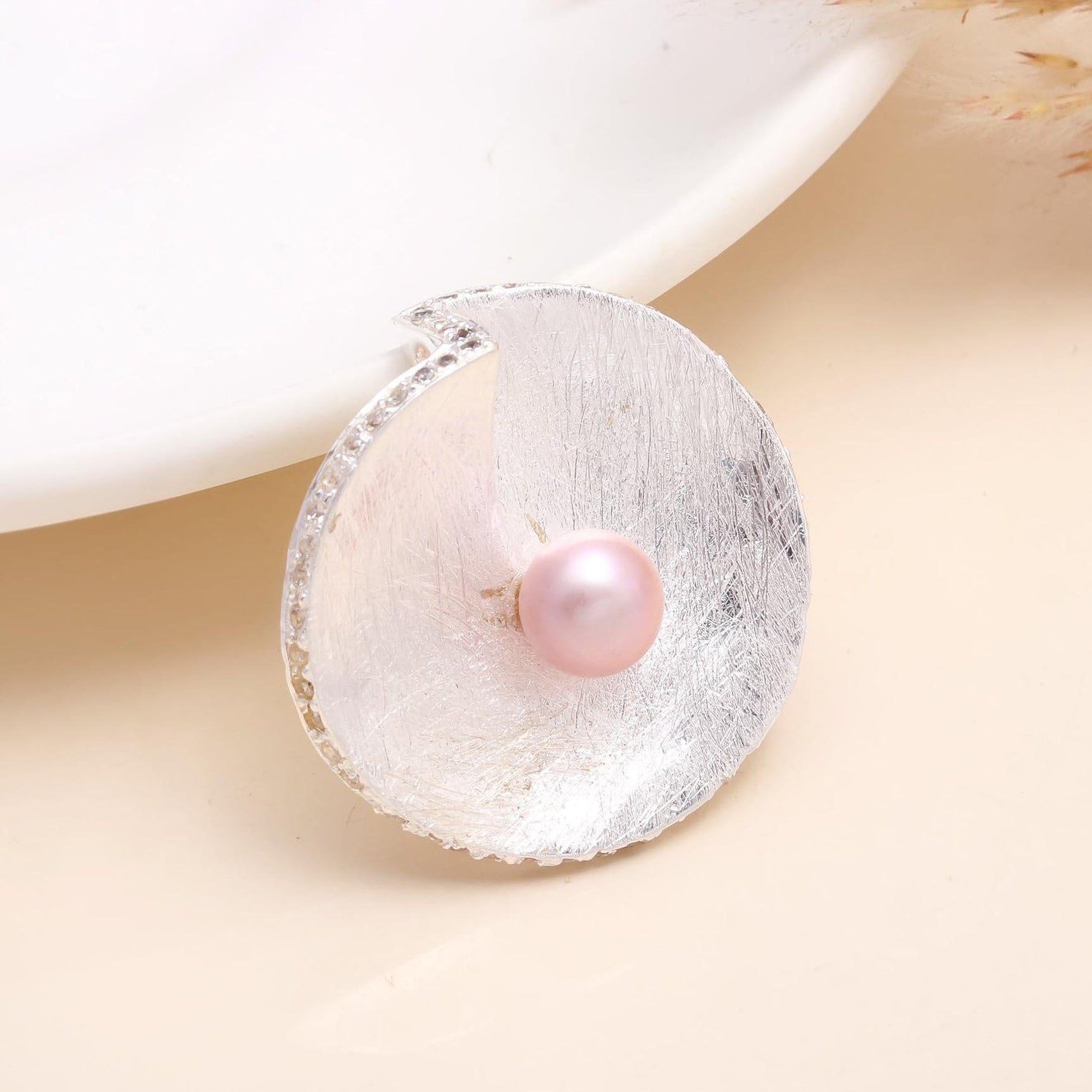 Pearl earring on a beige background
