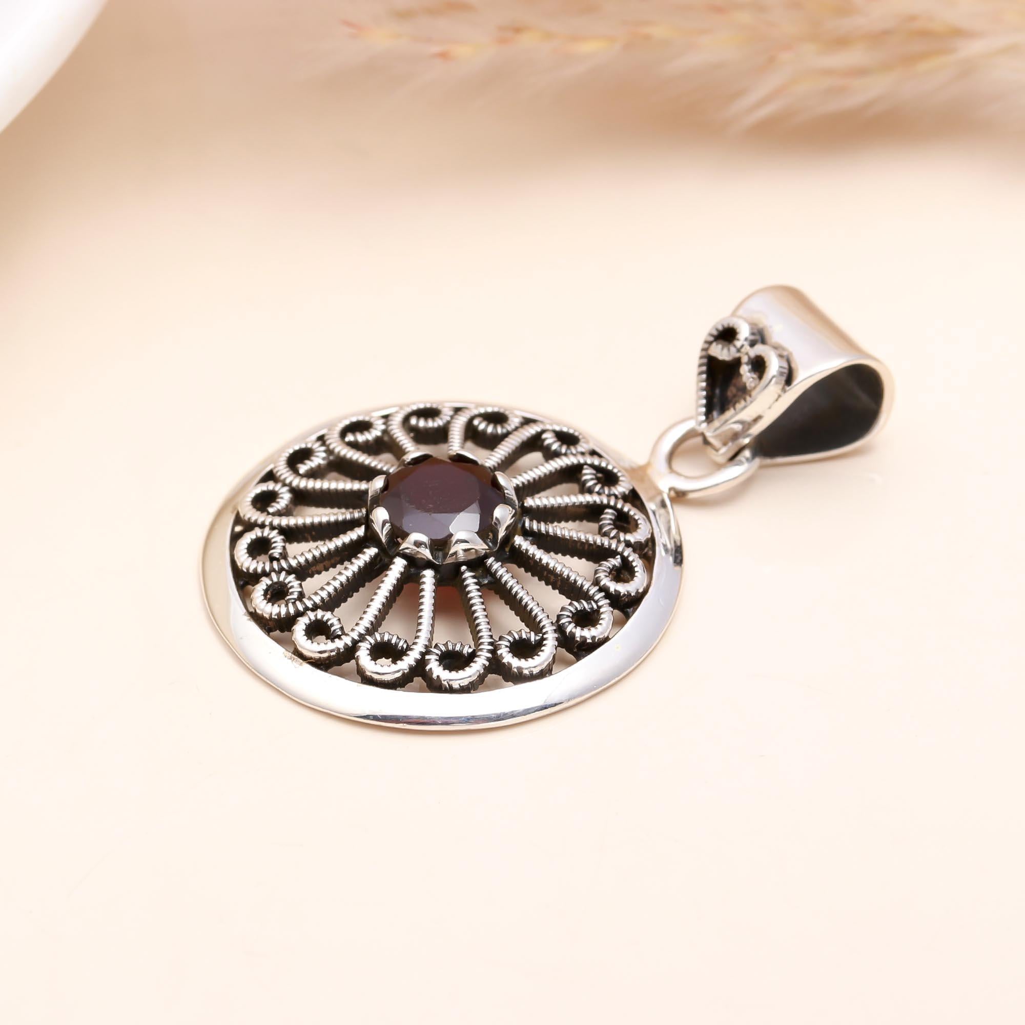 The Garnet Sunwheel: Ornate Silver Circular Pendant