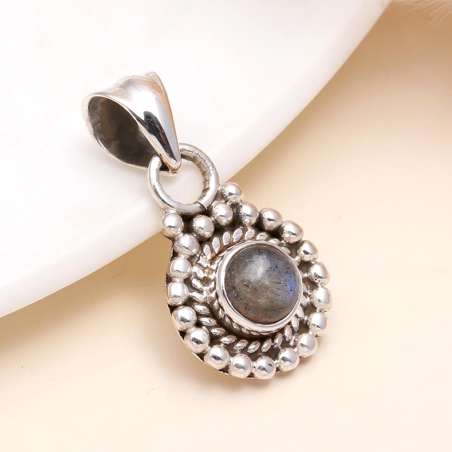 A 925 Sterling Silver Vintage Labradorite Boho Pendant with intricate detailing around the natural labradorite gemstone.