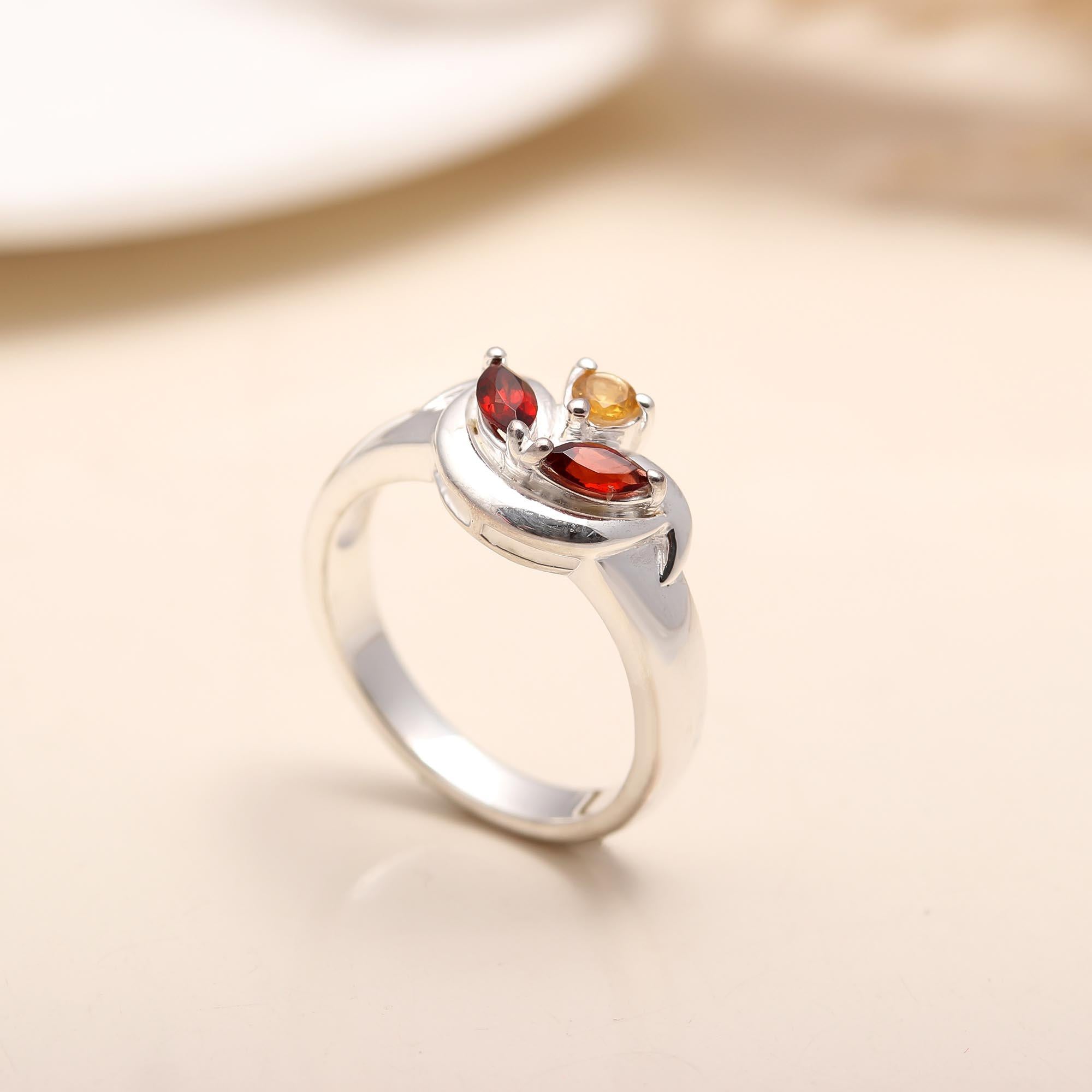 Side view showing the sleek silver band of the garnet ring.