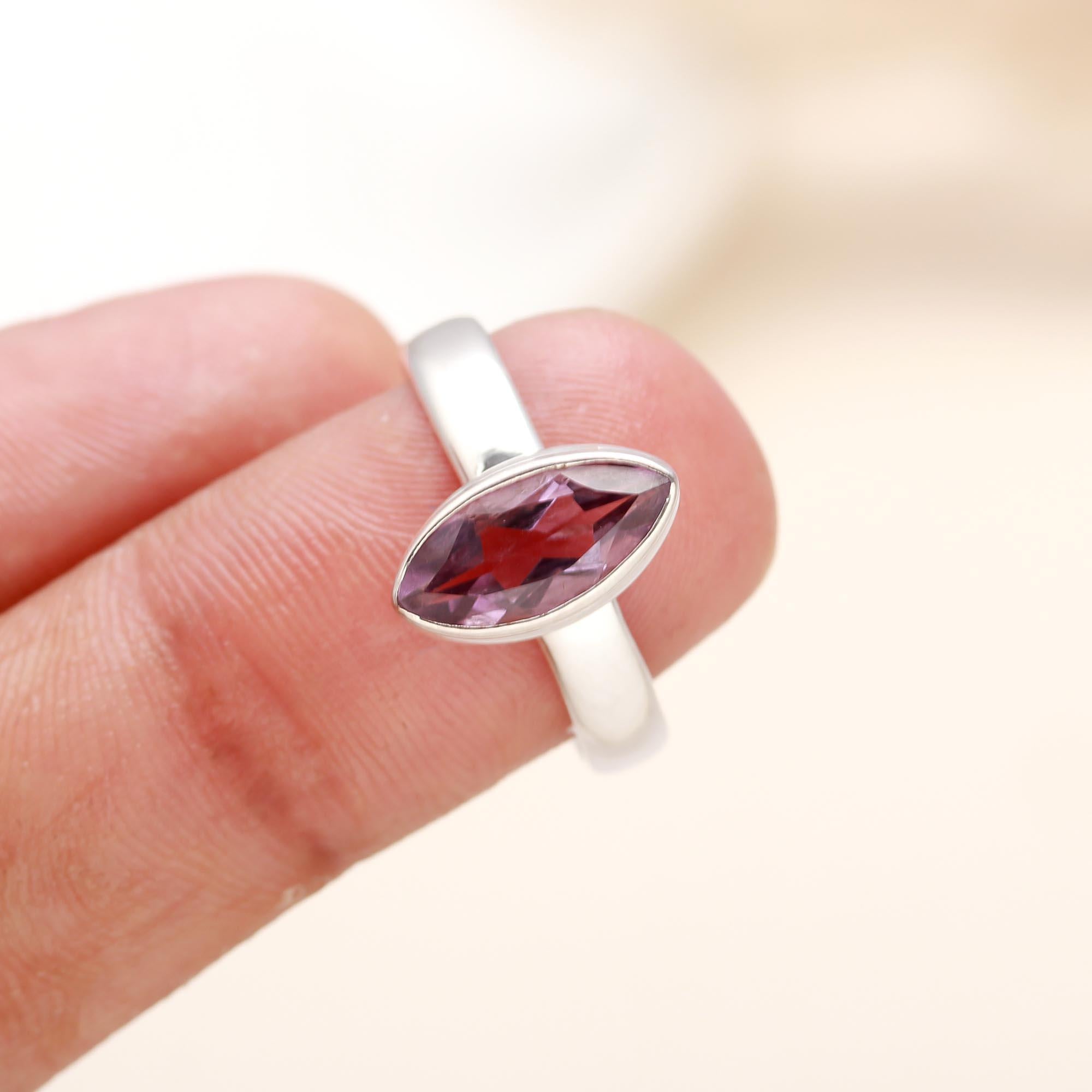 Close-up of marquise-cut amethyst in sterling silver solitaire band