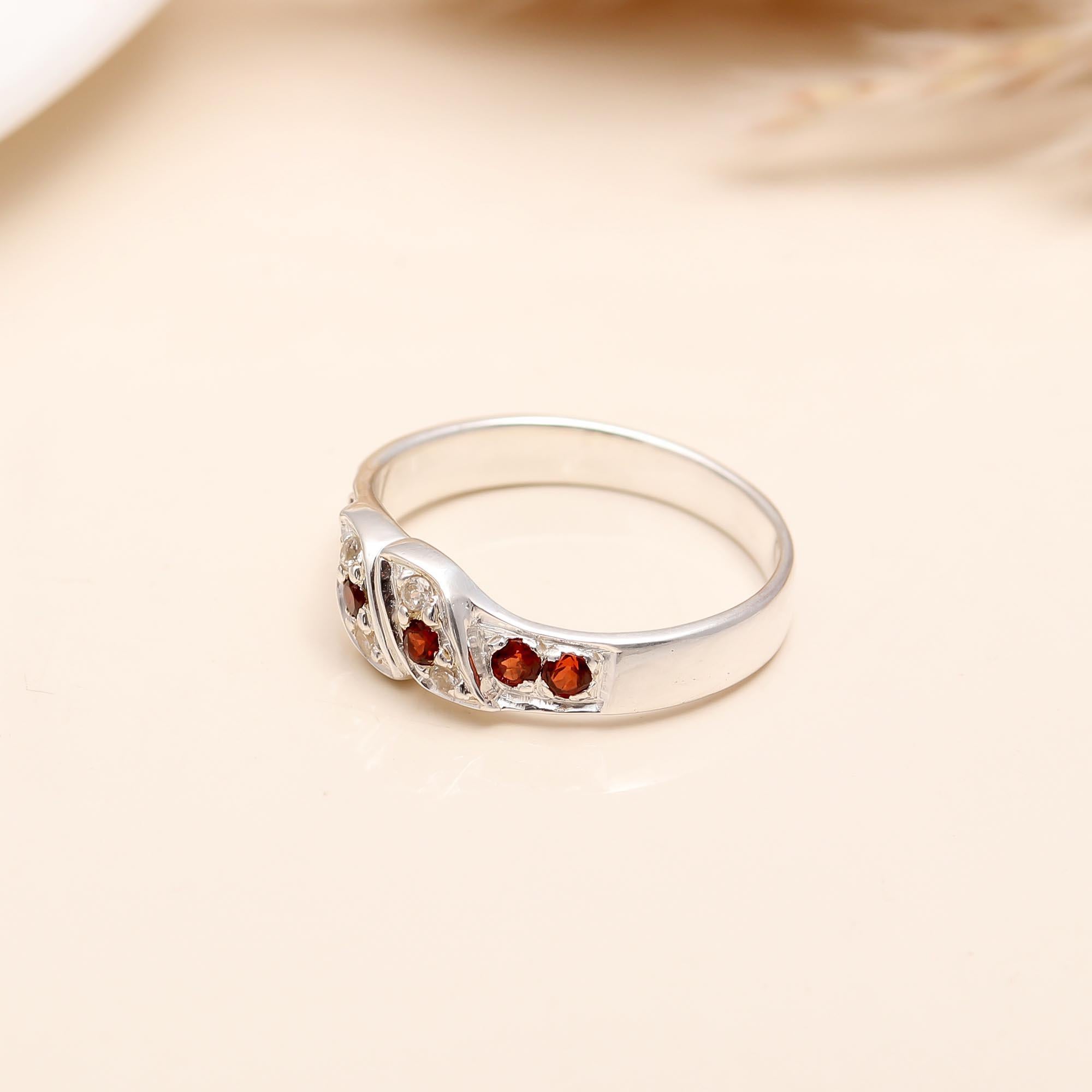 Elegant twist band silver ring with garnet and CZ stones