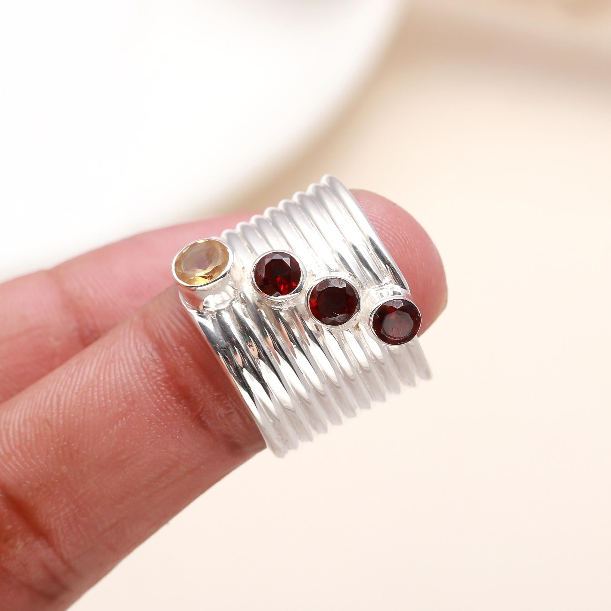 Elegant garnet and citrine ring on finger