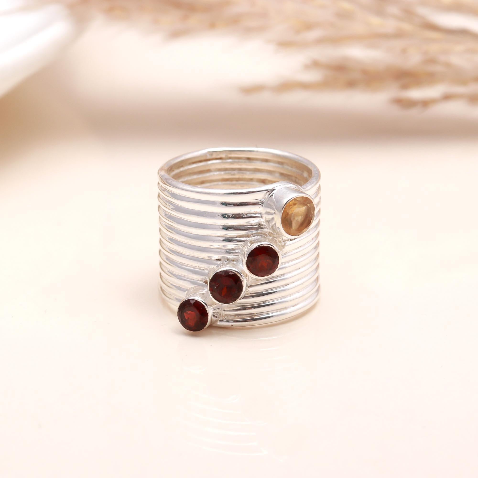 Close-up of garnet and citrine ribbed silver ring