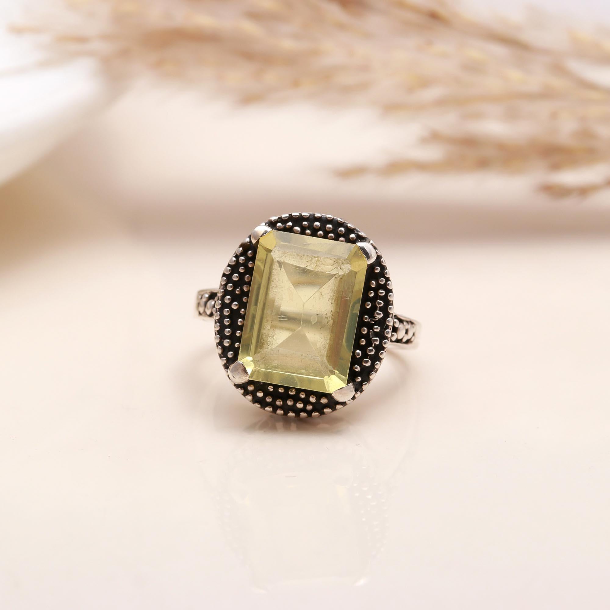 Close-up of emerald cut lemon quartz vintage silver ring