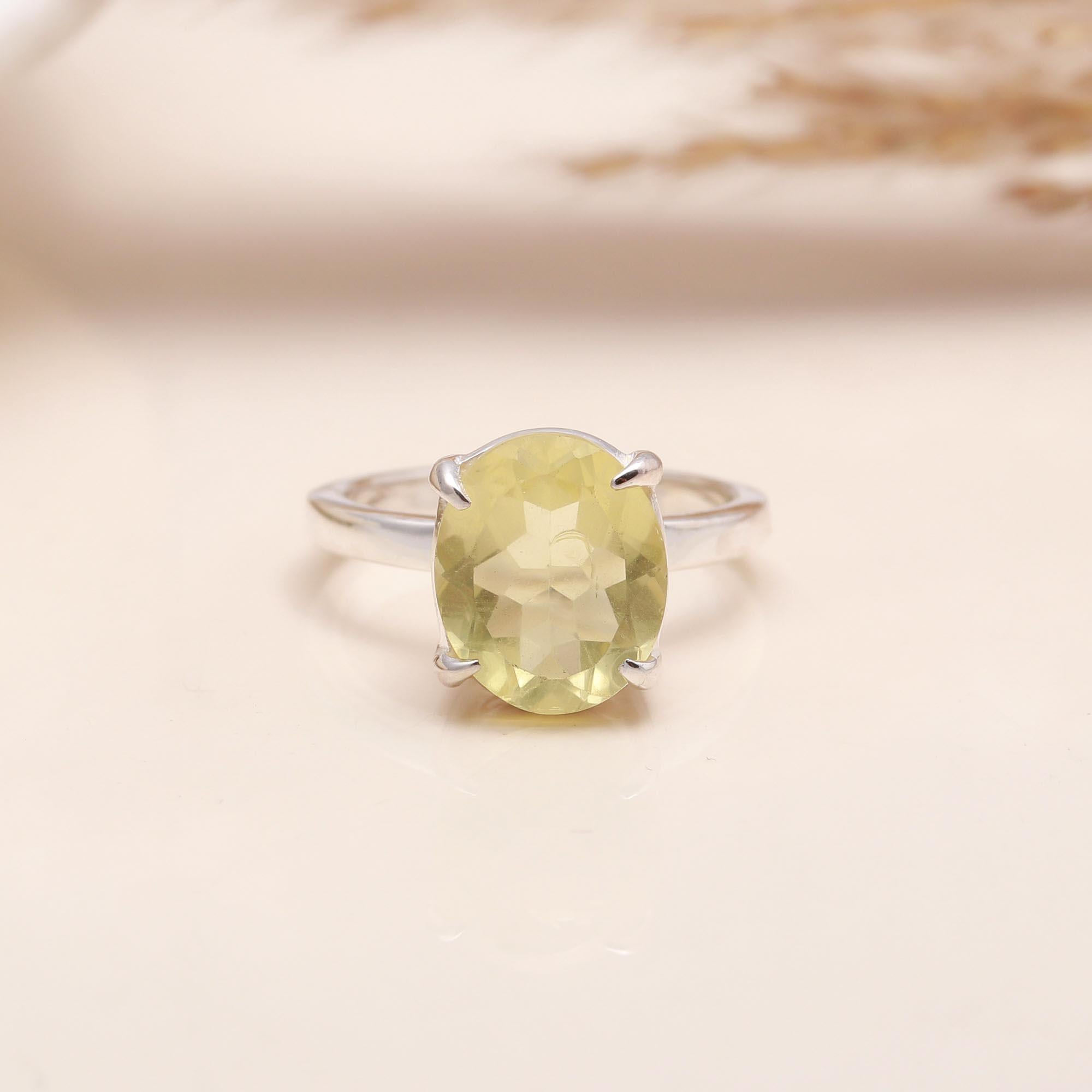 Close-up of oval lemon quartz solitaire silver ring