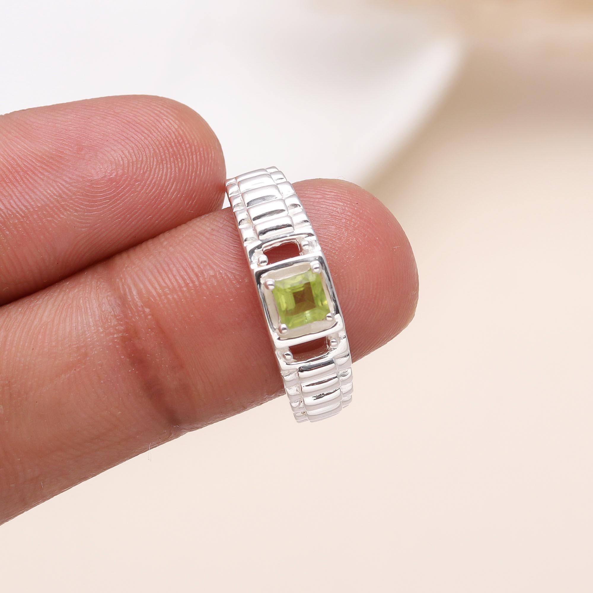 Elegant square peridot ring on finger