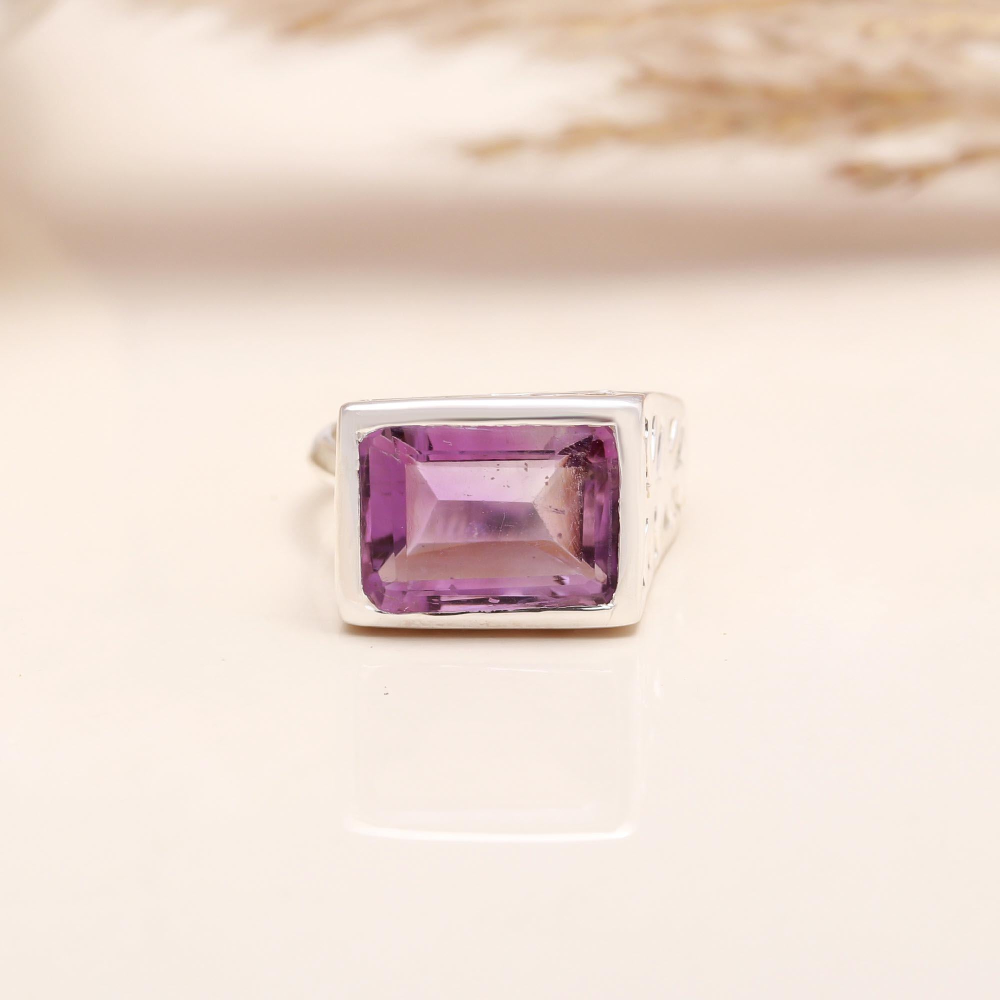 Faceted emerald-cut amethyst solitaire silver ring close-up