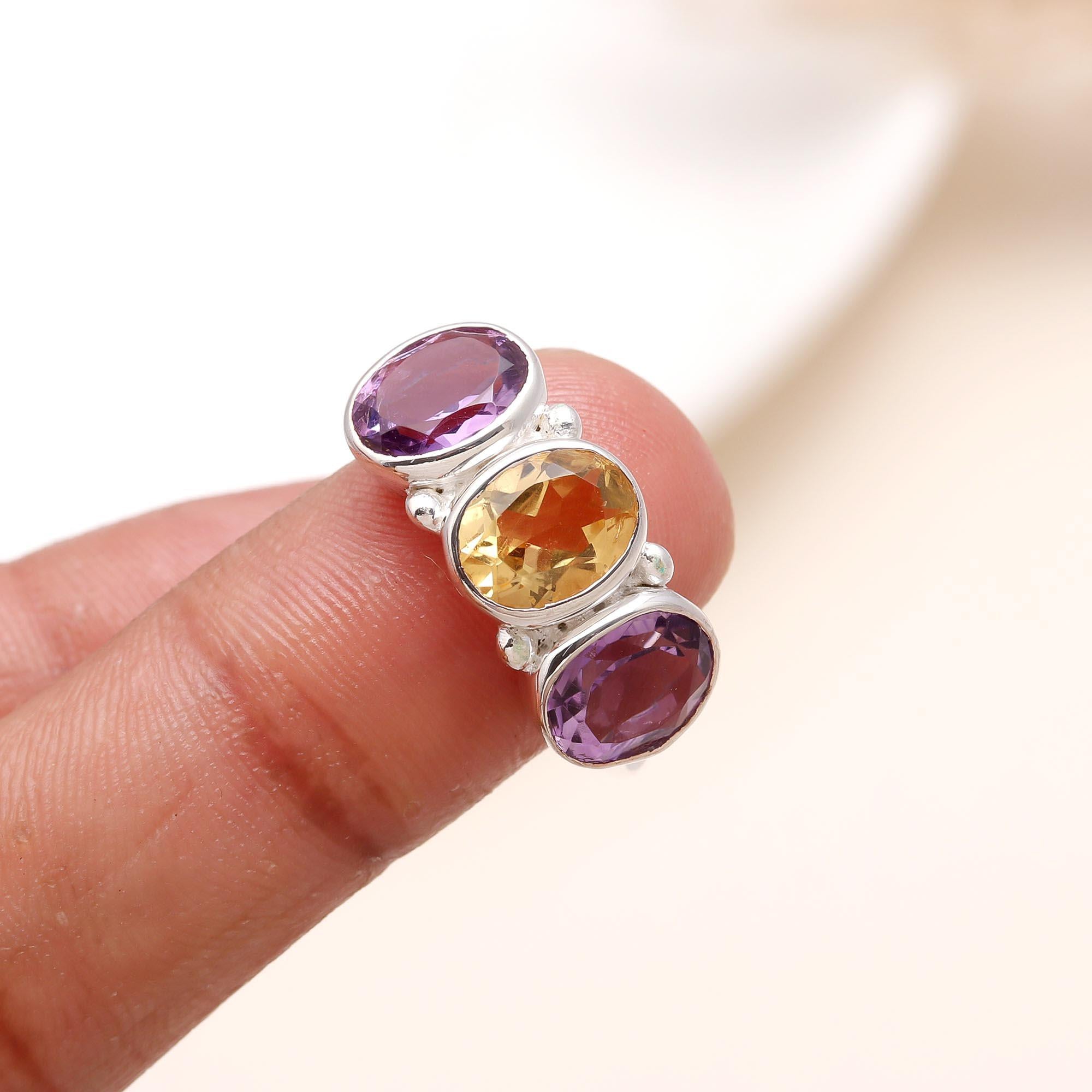 Elegant amethyst and citrine ring on finger