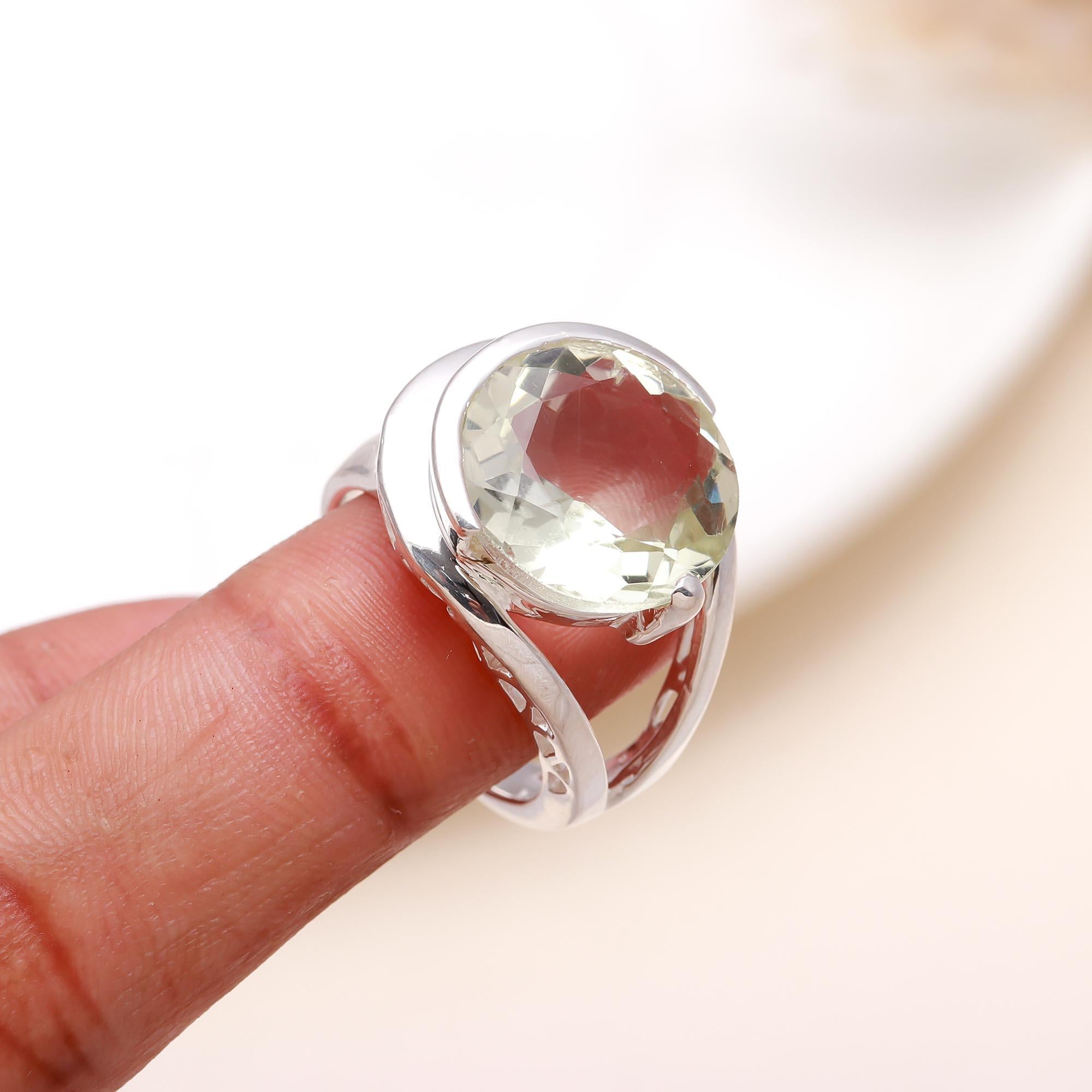 Elegant green amethyst crossover gemstone ring on finger