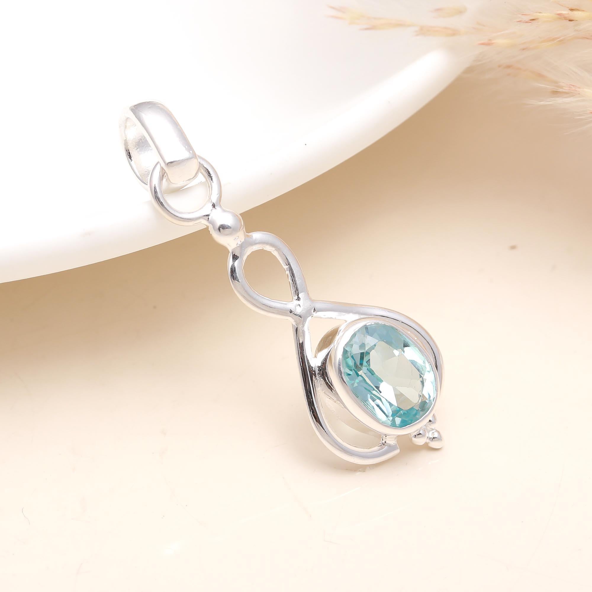 The Azure Drop: Blue Topaz Oval Cabochon Pendant