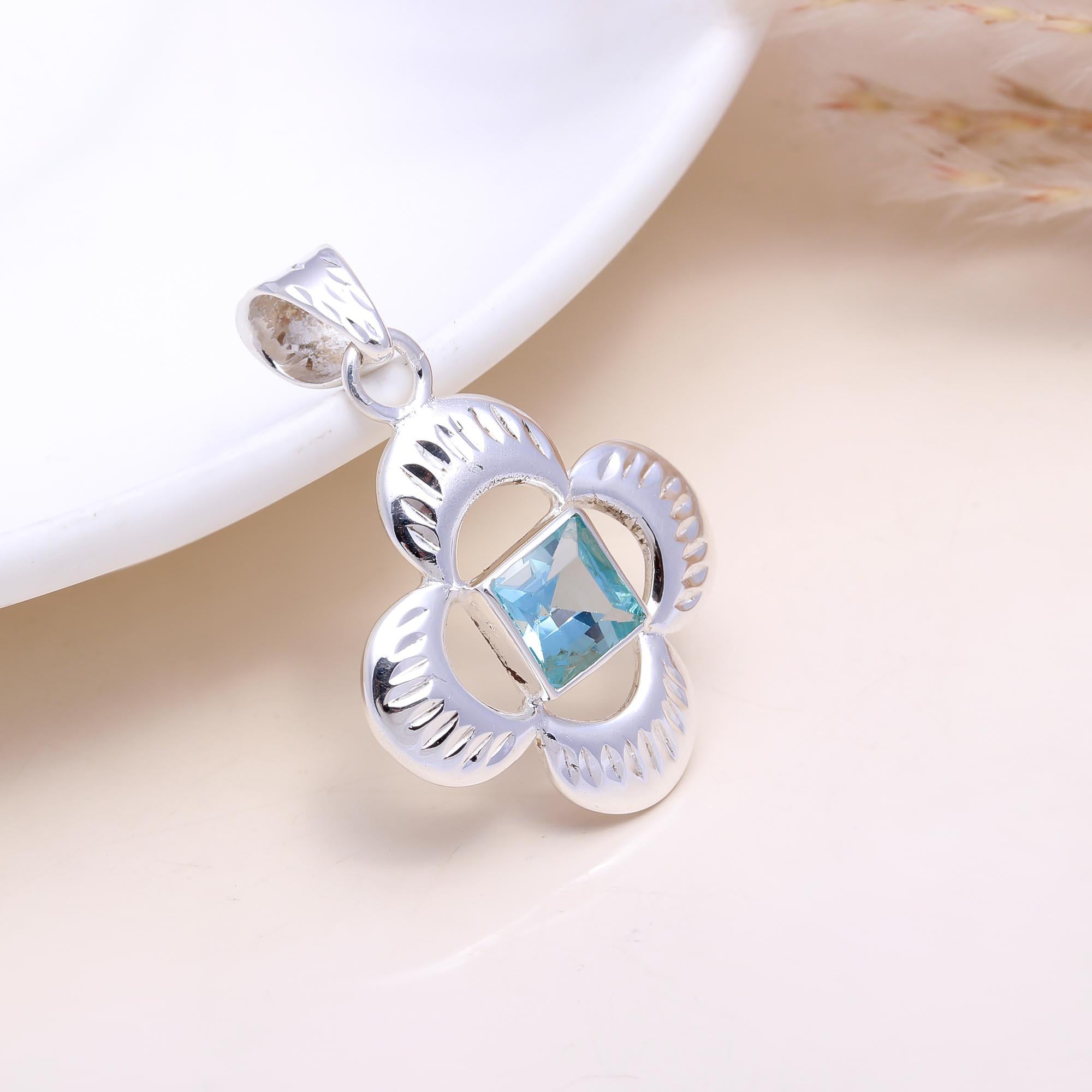 The Azure Clover: Blue Topaz Cutout Flower Pendant