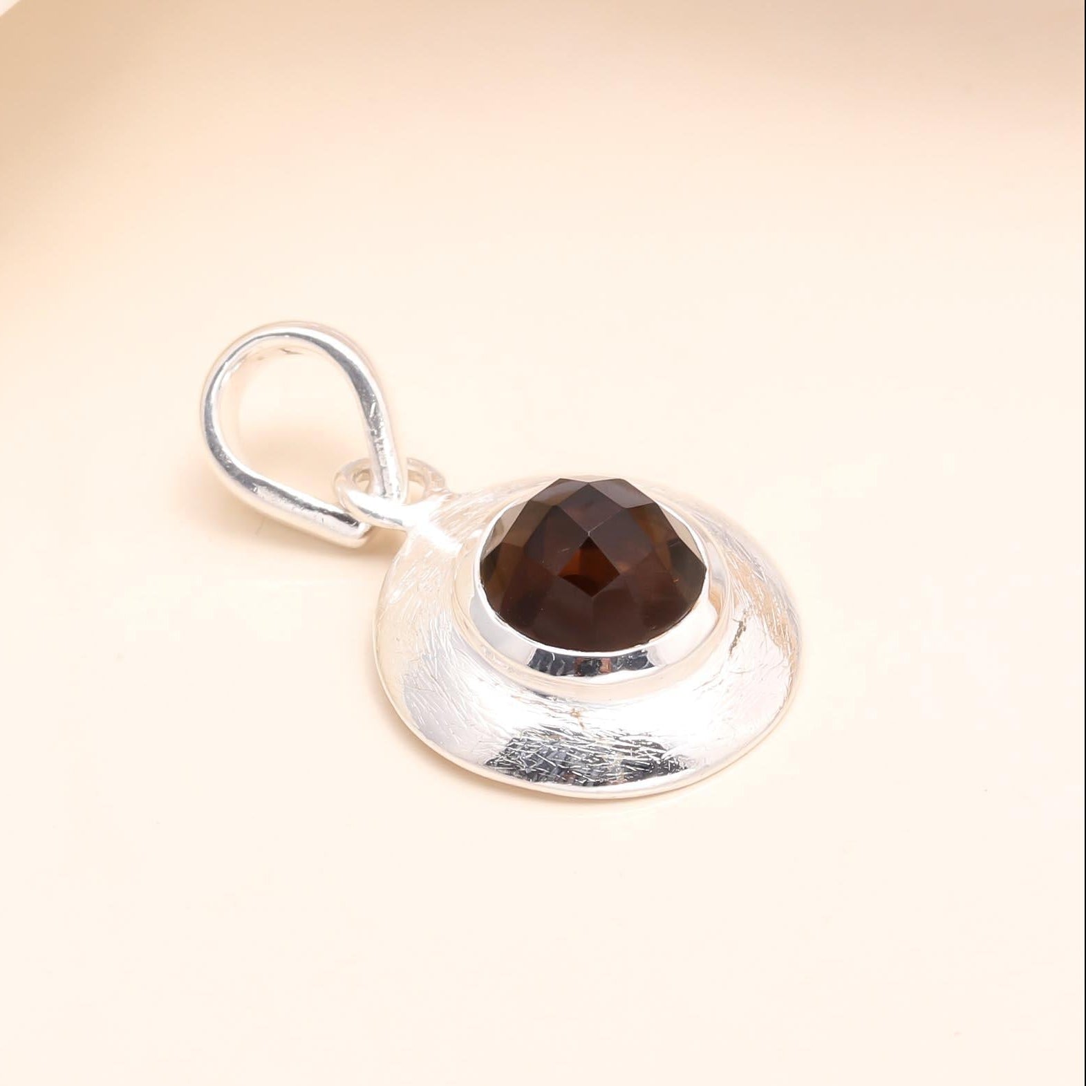 A 925 Sterling Silver Smoky Quartz Pendant with a sleek finish, showcasing the gemstone in a round cut and mounted in a silver frame with a loop for attachment.