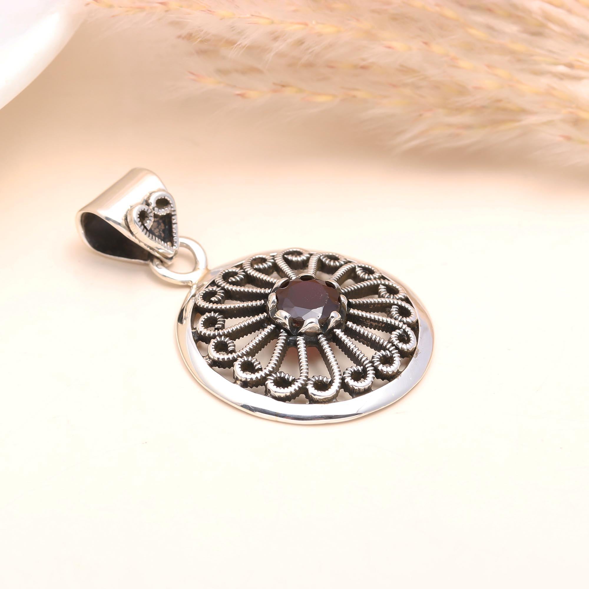 The Garnet Sunwheel: Ornate Silver Circular Pendant