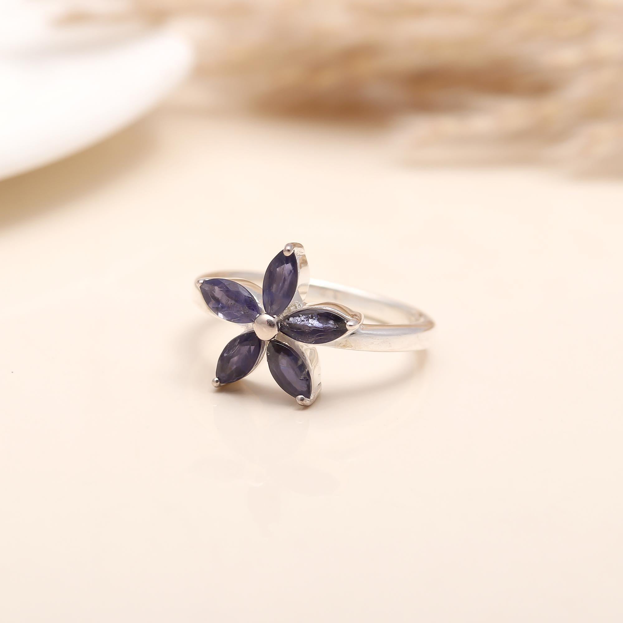Hand model wearing 925 silver iolite petal flower ring