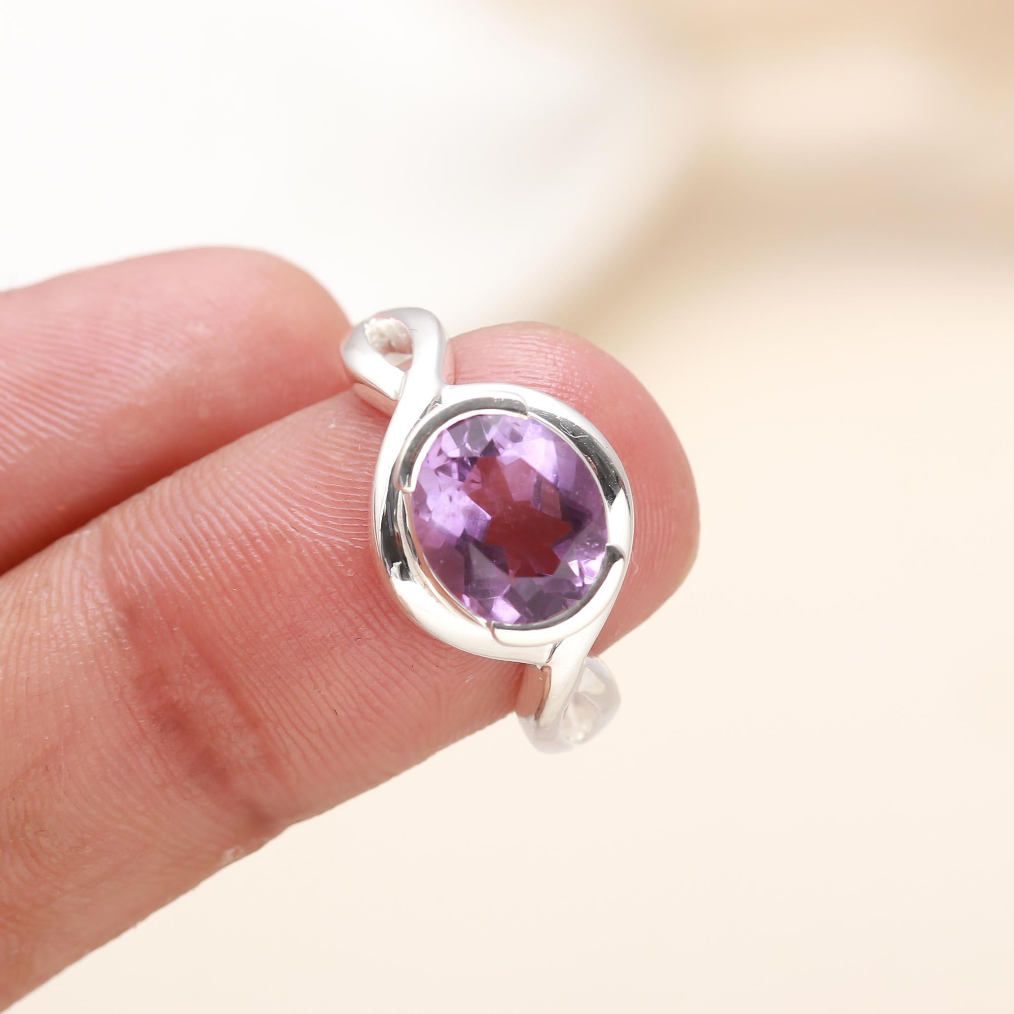 Close-up of violet amethyst set in sterling silver oval ring