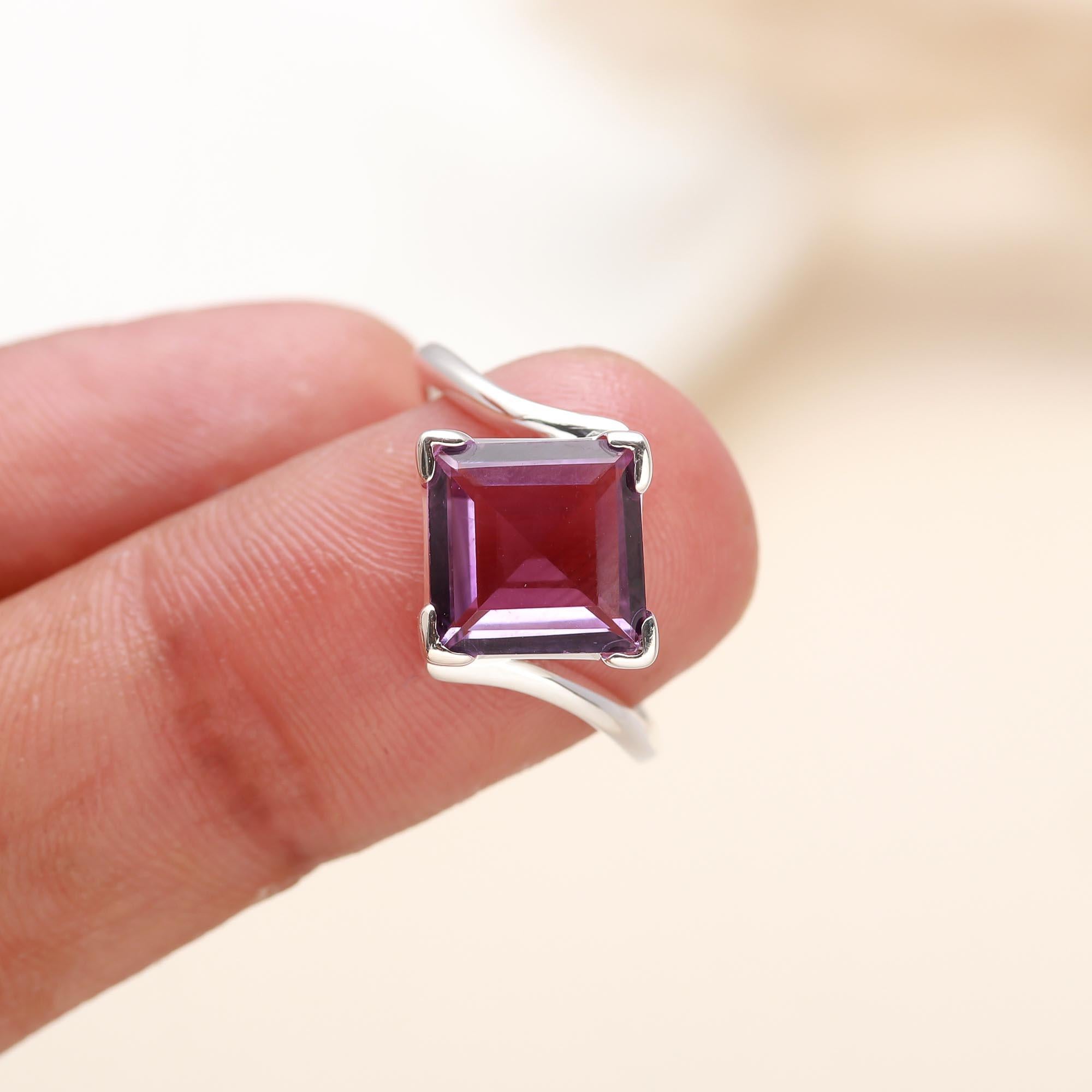 Close-up of square-cut amethyst set in sterling silver solitaire band