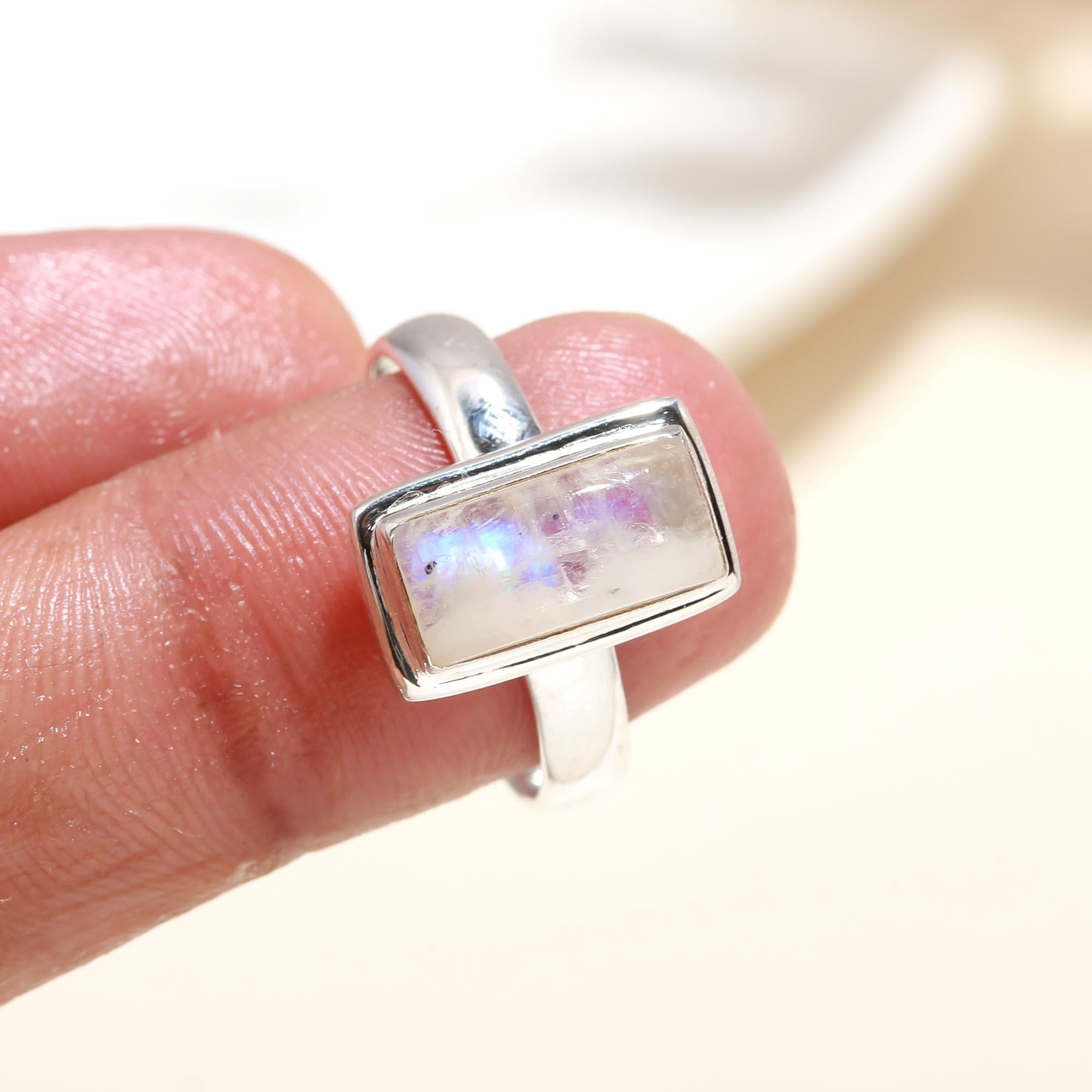 Elegant rectangular moonstone ring on finger