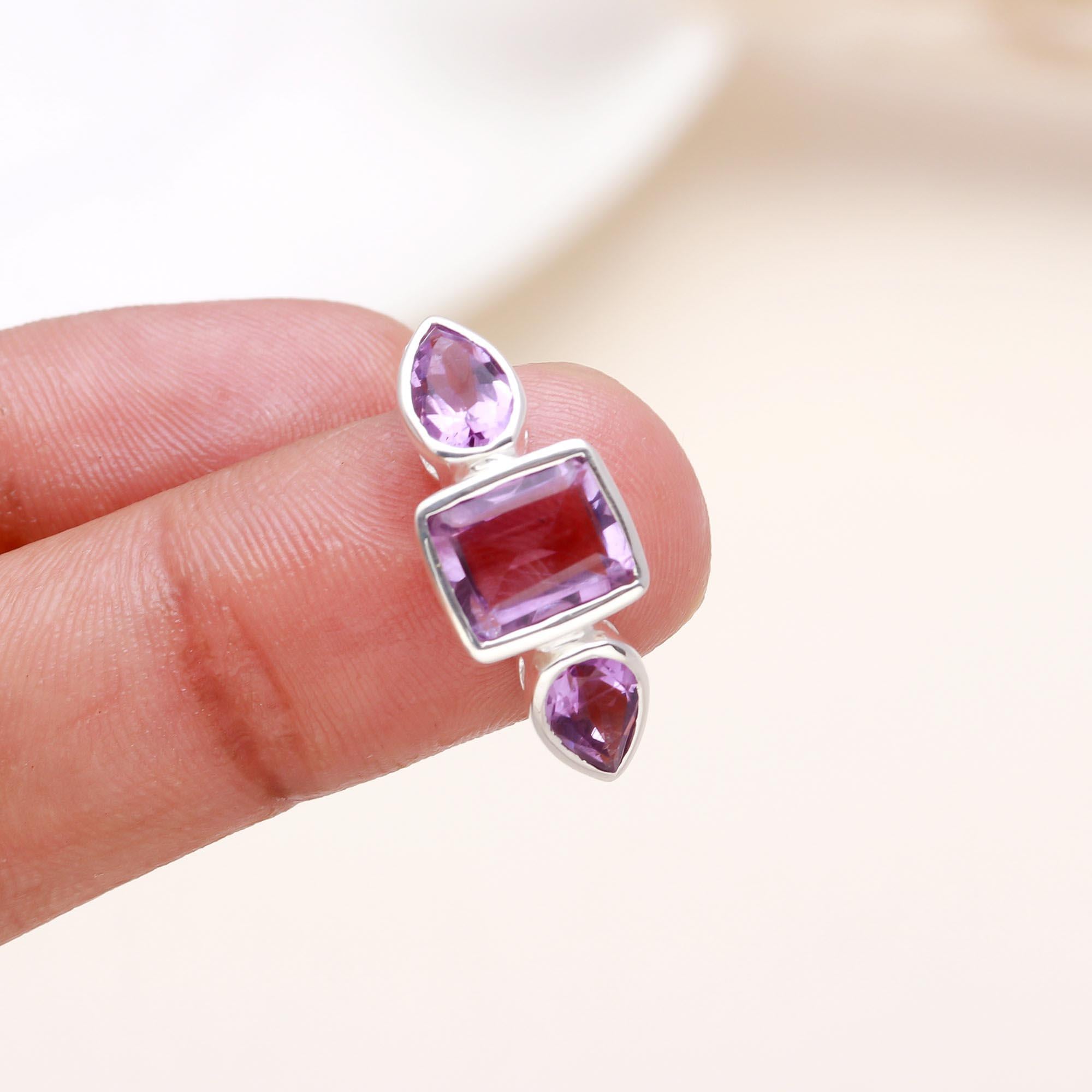 Elegant amethyst pear and baguette ring on finger