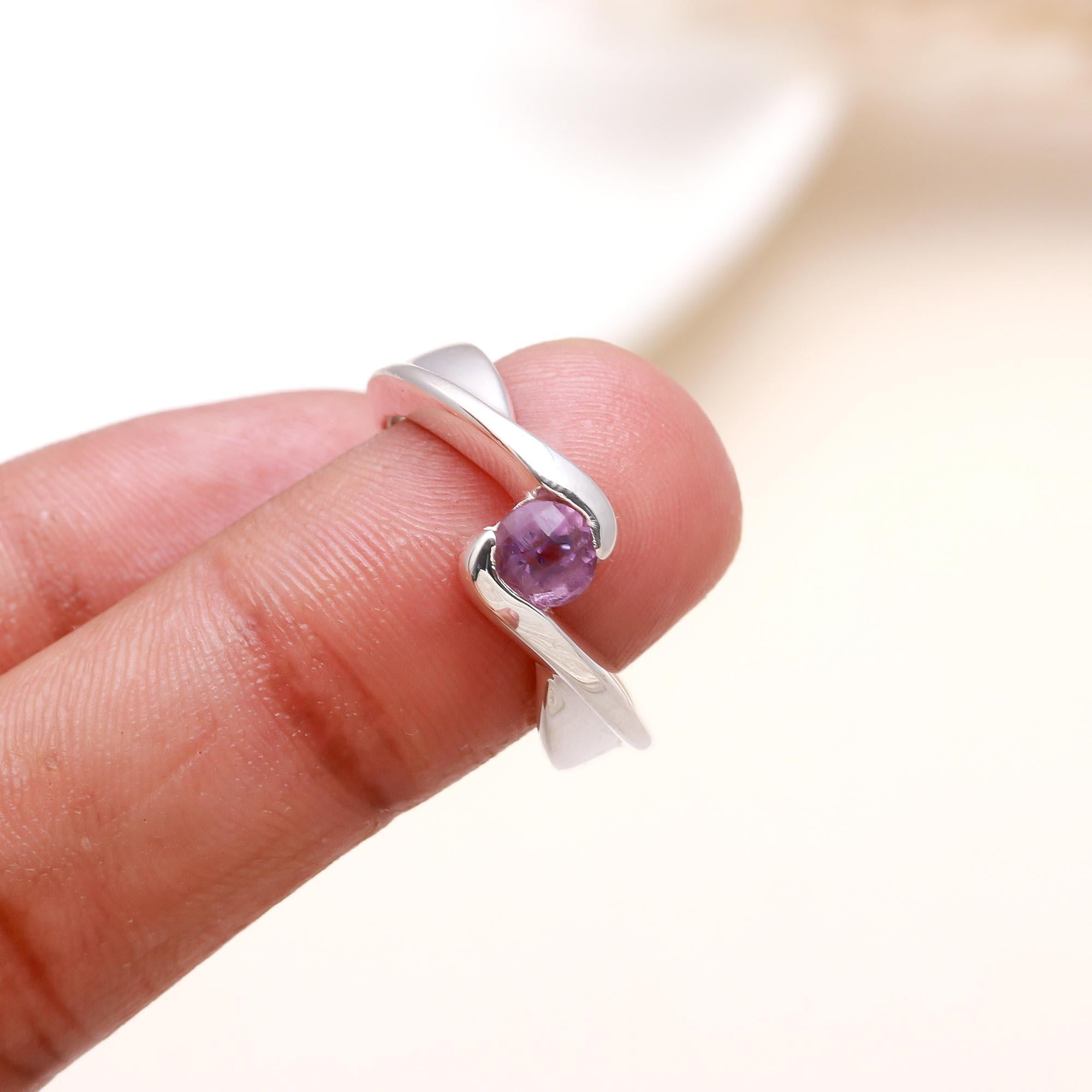 Purple gemstone silver bypass ring on finger