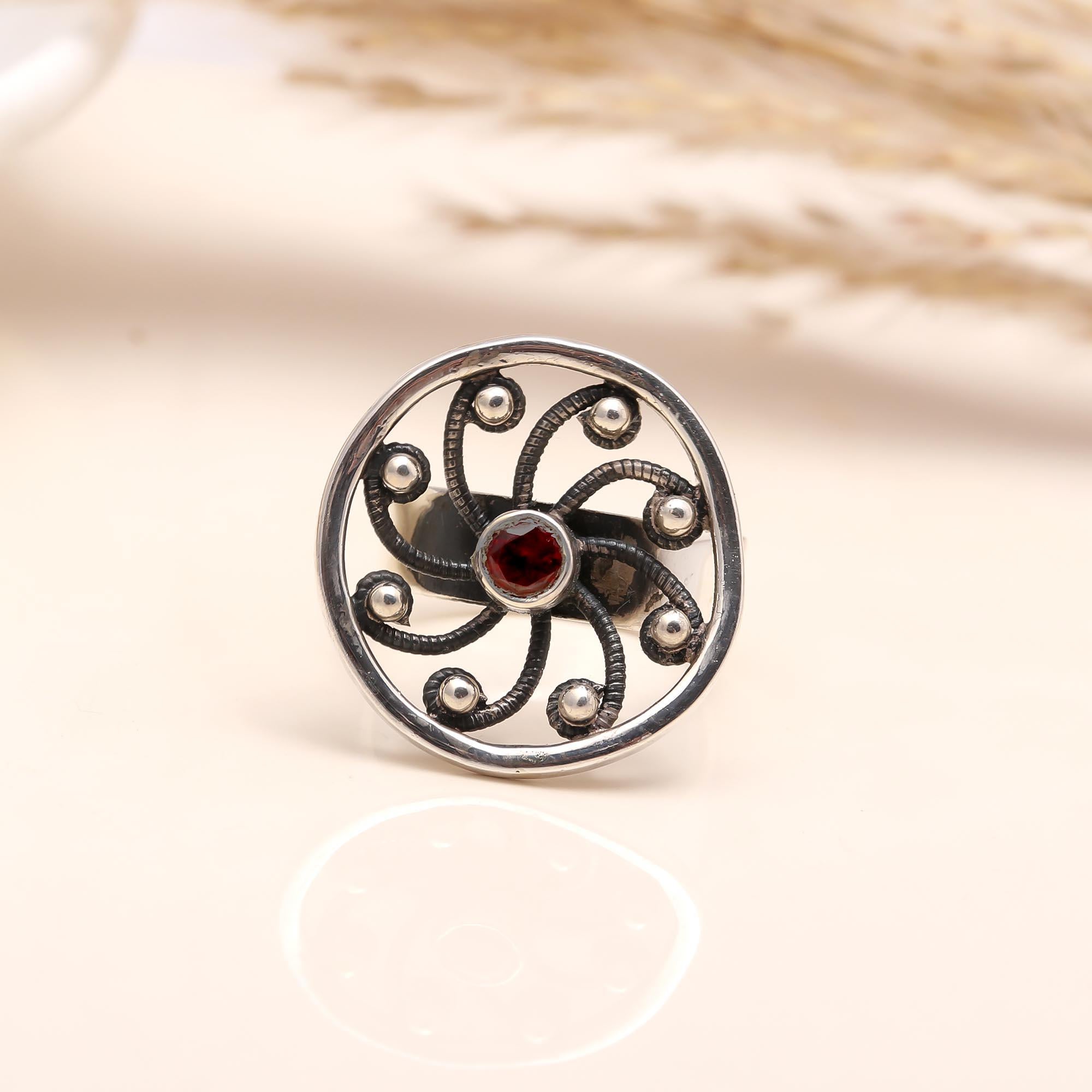Close-up of vintage-style silver garnet ring